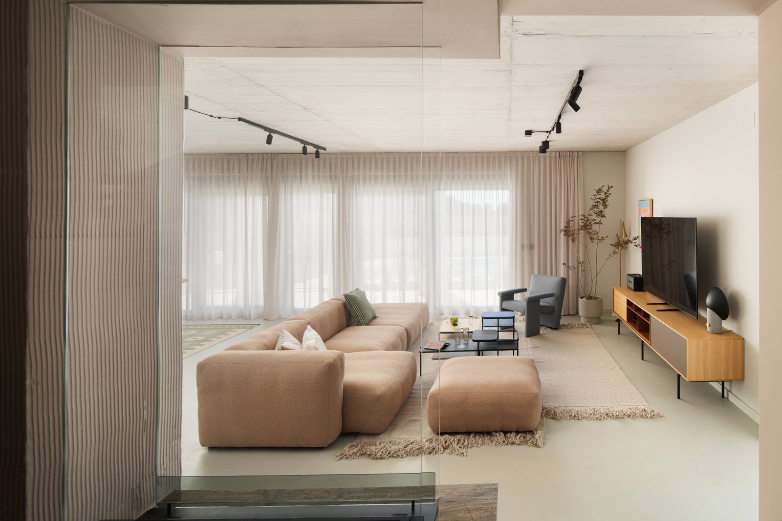 Arc House: living room with a soft beige sofa