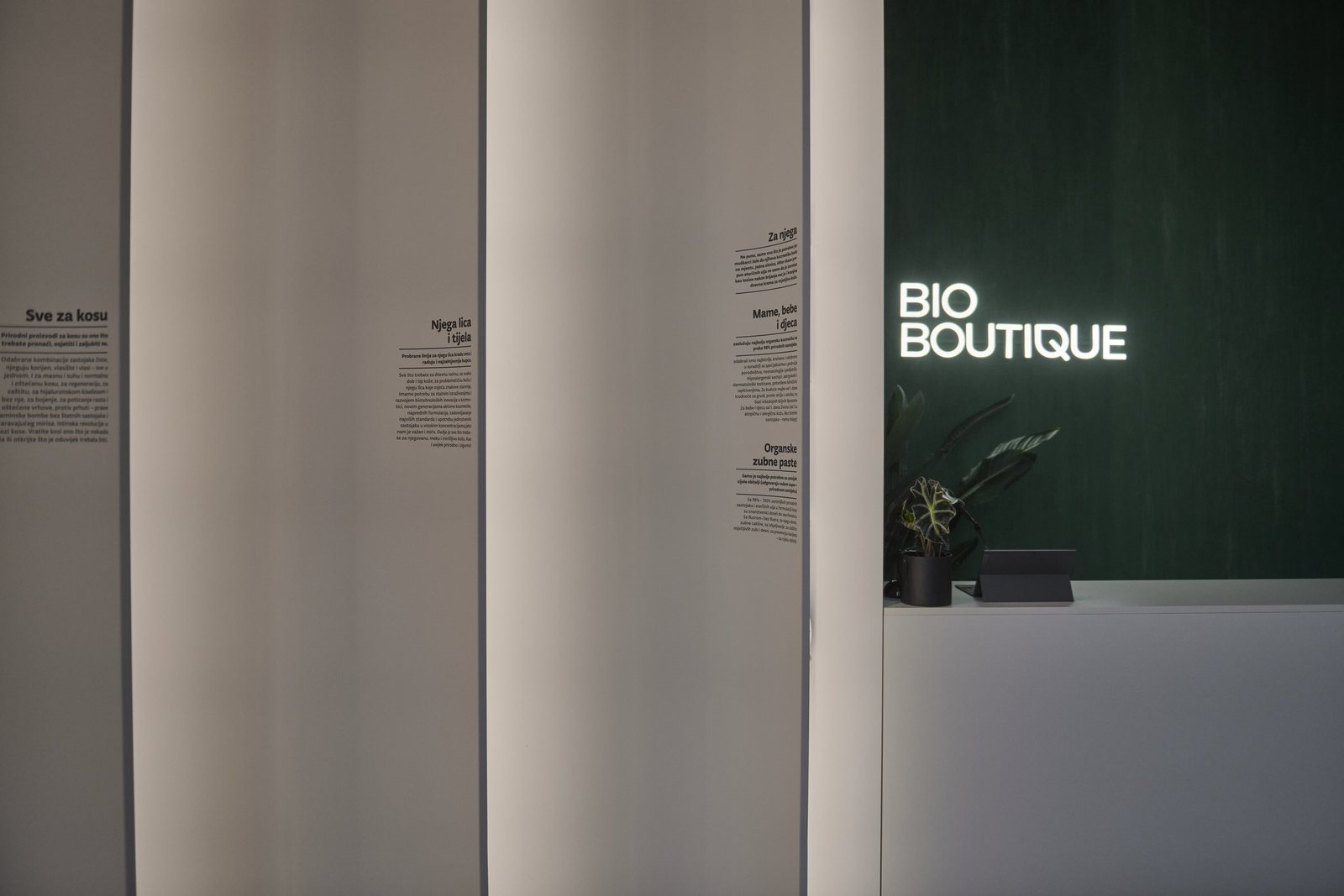 Bio Boutique: curved white panels and the lit Bio Boutique sign
